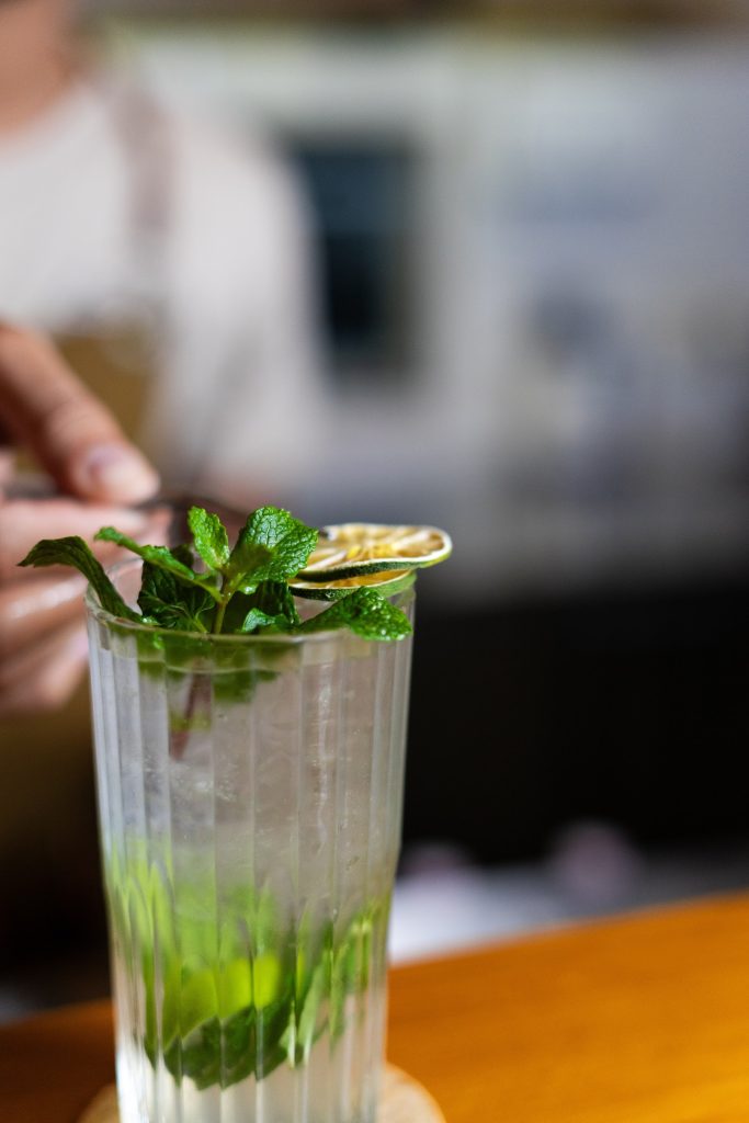 Bartender garnishing a fresh mojito at Camino Bali