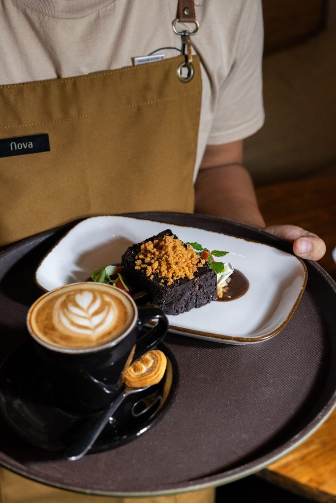 Tray with latte and chocolate dessert at Camino Bali