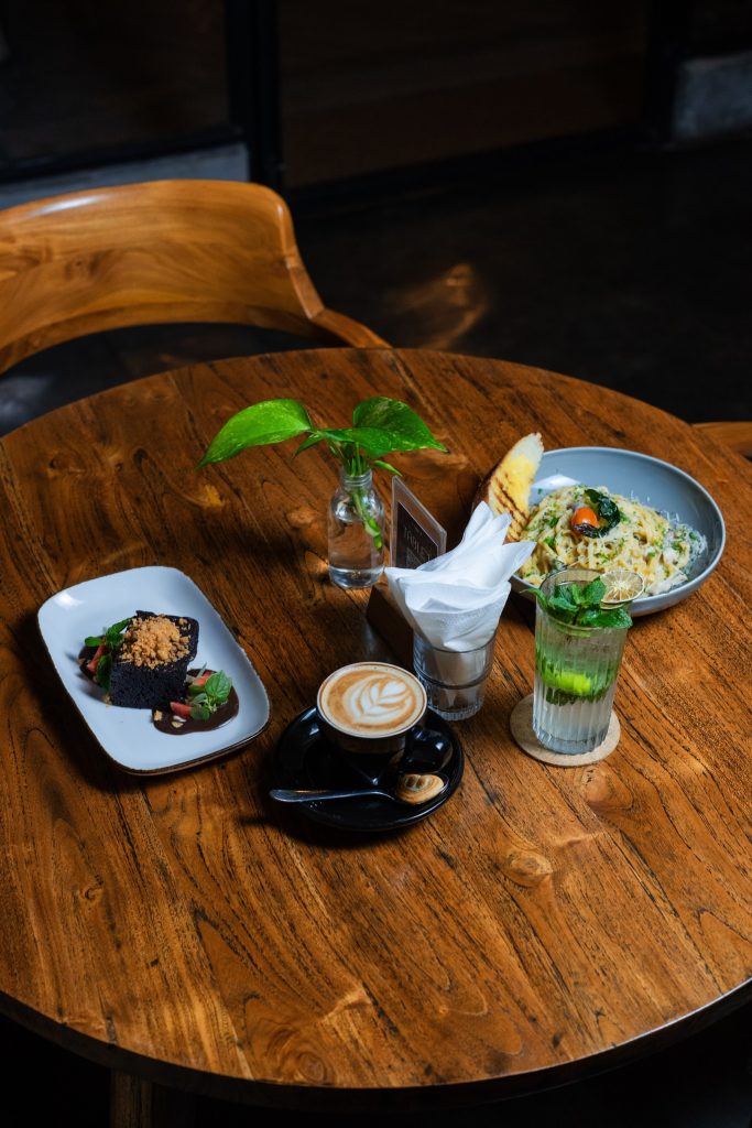 Table spread of dishes, desserts and drinks at Camino Bali